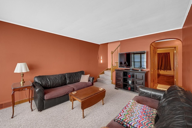 living room with light colored carpet and ornamental molding