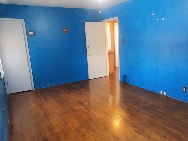 spare room with dark hardwood / wood-style floors