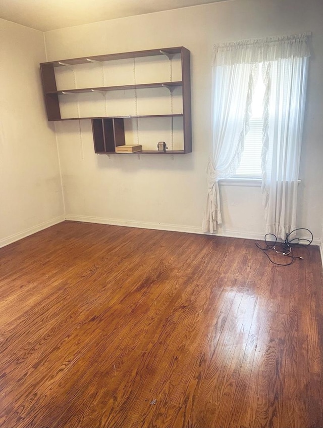 unfurnished room featuring dark hardwood / wood-style floors