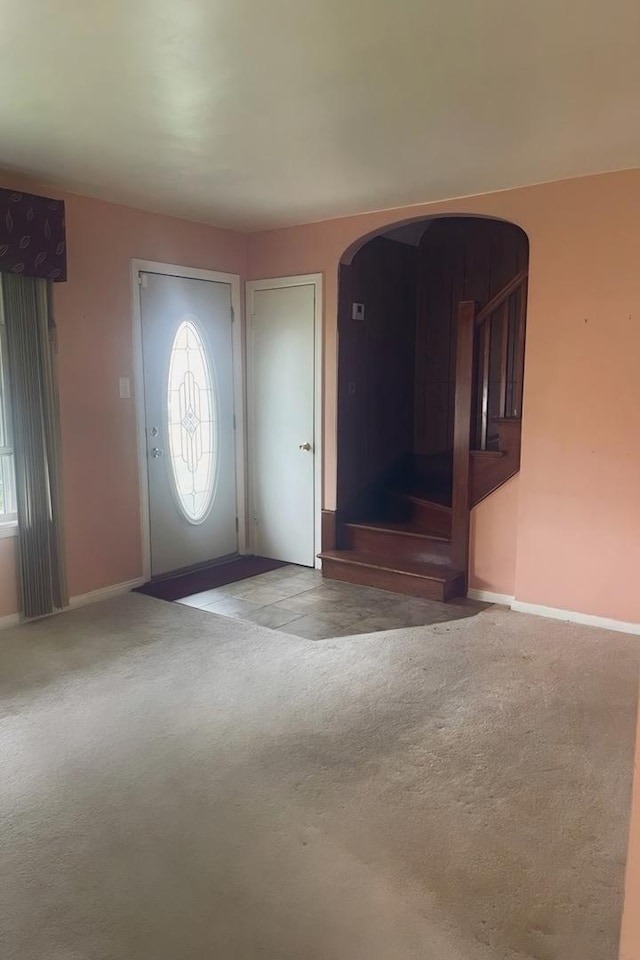 foyer with carpet flooring and a healthy amount of sunlight