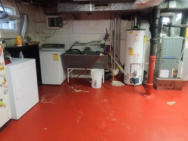 basement with washing machine and dryer and water heater