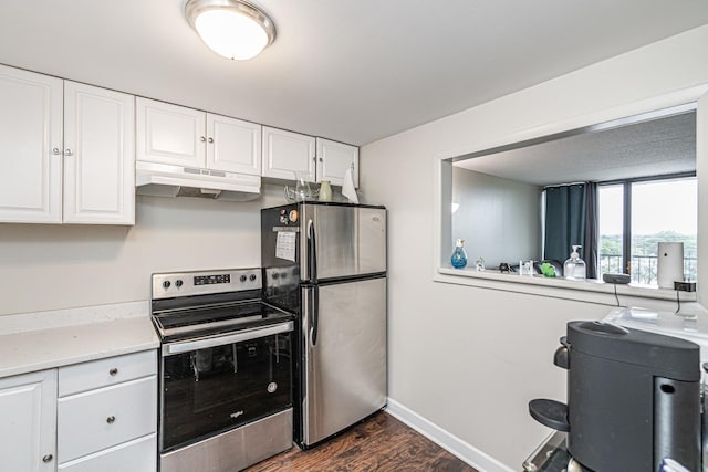 kitchen featuring white cabinets, appliances with stainless steel finishes, and dark wood-type flooring