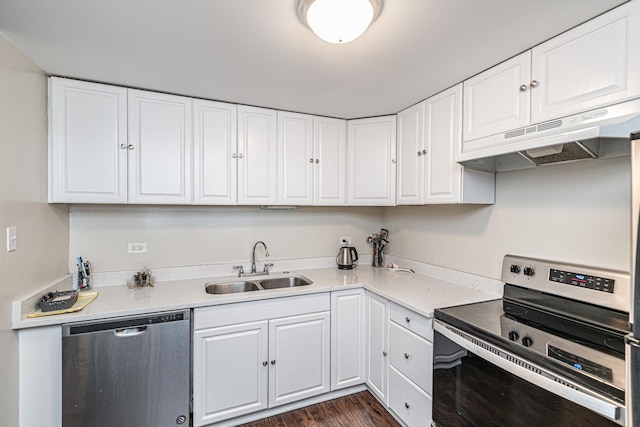 kitchen featuring stainless steel appliances, extractor fan, sink, white cabinets, and dark hardwood / wood-style floors