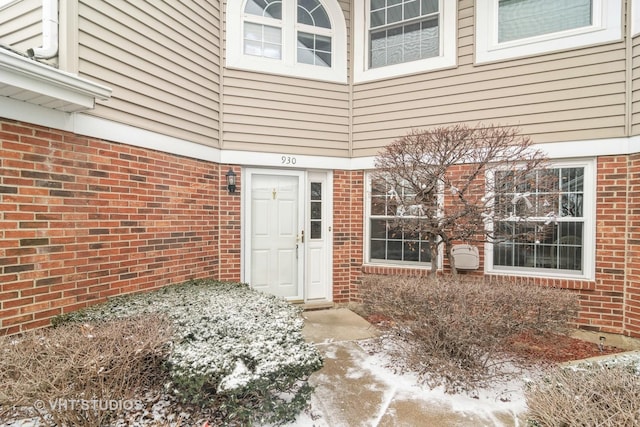 view of snow covered property entrance