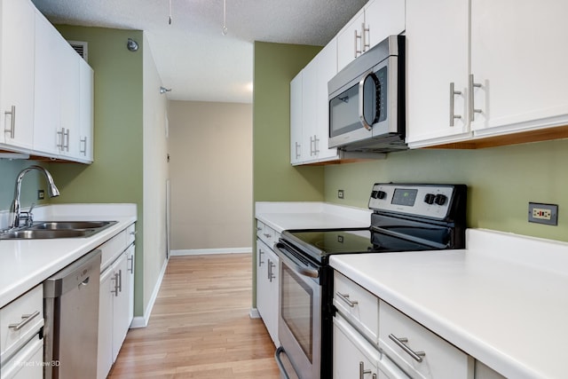 kitchen featuring sink, white cabinets, and stainless steel appliances