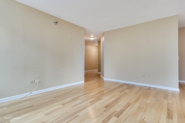 spare room featuring light wood-type flooring