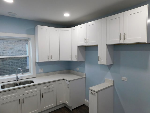 kitchen featuring white cabinets, dark hardwood / wood-style floors, and sink