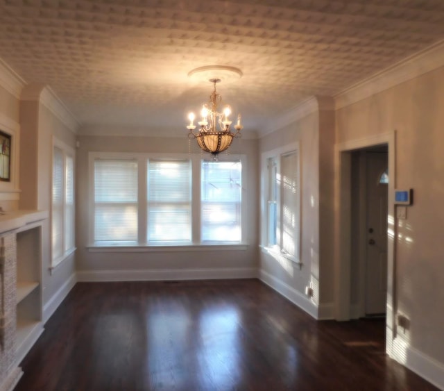 unfurnished dining area with crown molding, dark wood-type flooring, and an inviting chandelier