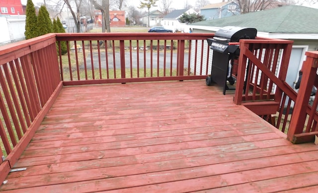 wooden terrace with a grill