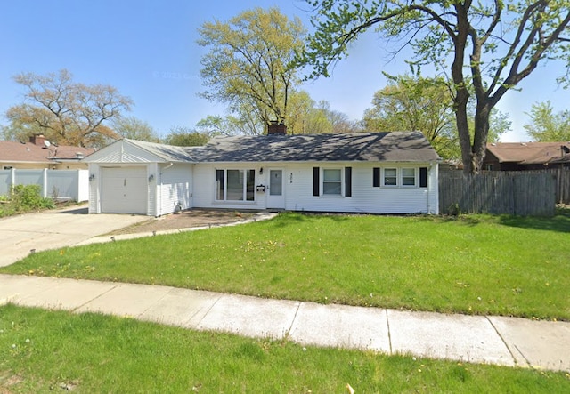 ranch-style home featuring a garage and a front lawn