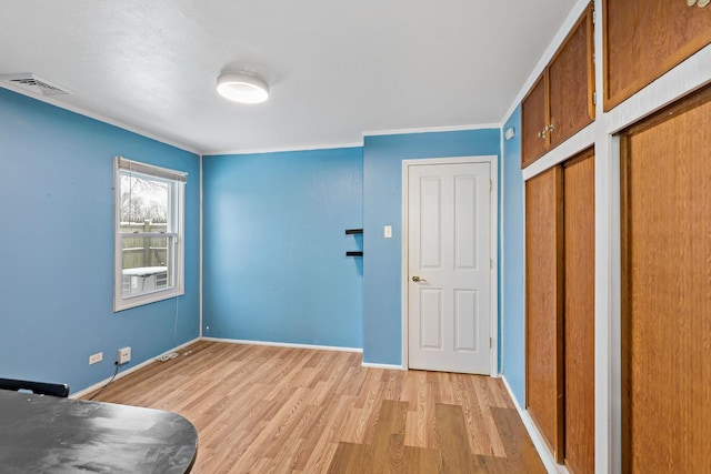 entrance foyer with light wood-type flooring and crown molding