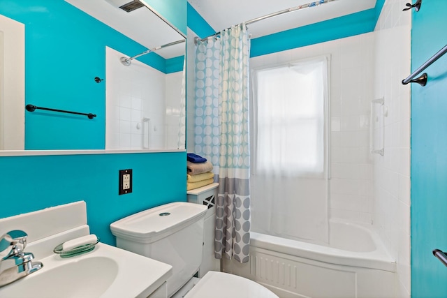 full bathroom featuring sink, toilet, and shower / tub combo with curtain