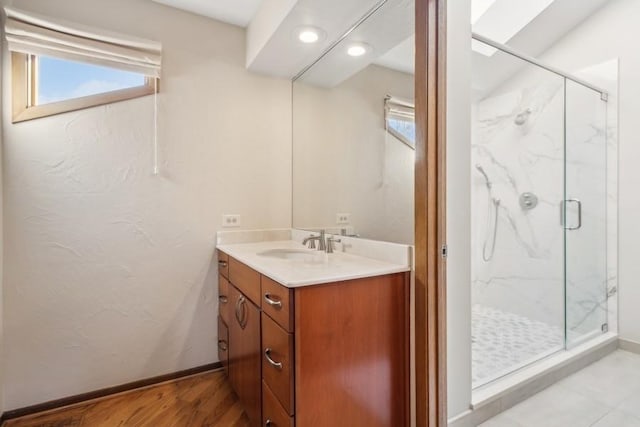 bathroom featuring vanity, hardwood / wood-style floors, and walk in shower