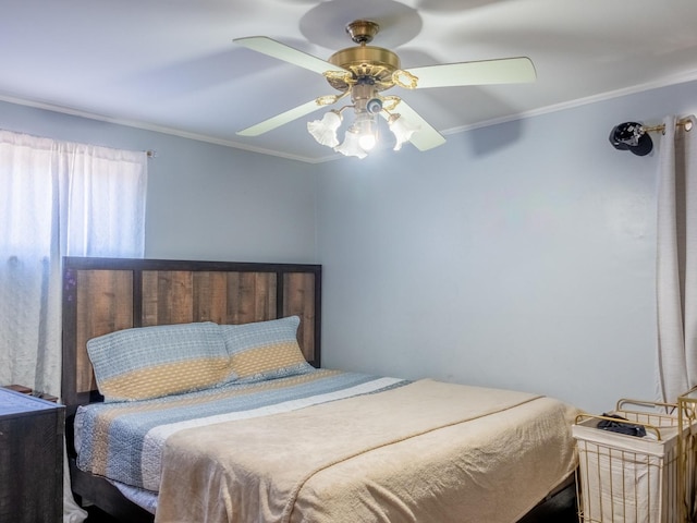 bedroom featuring ceiling fan and crown molding