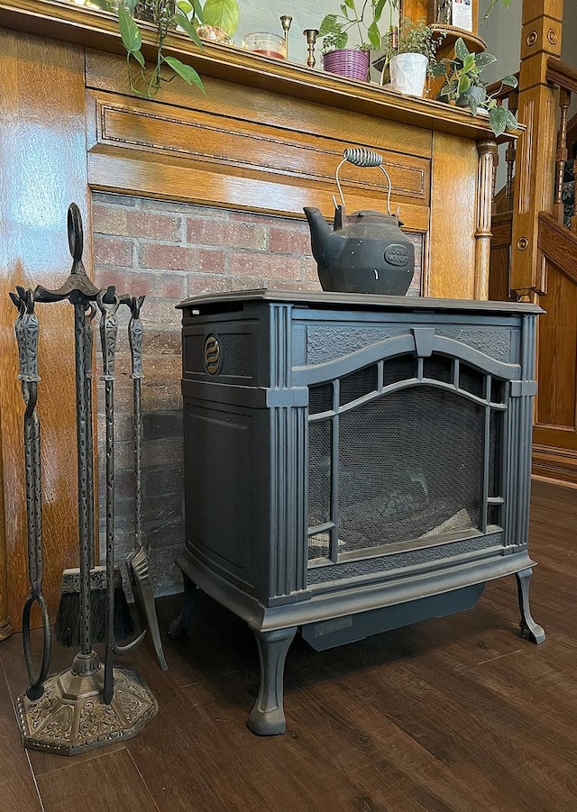 room details with a wood stove and hardwood / wood-style flooring