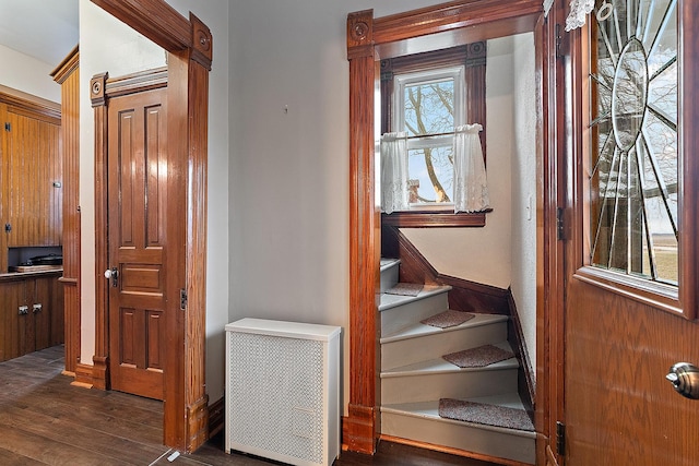 staircase with hardwood / wood-style flooring