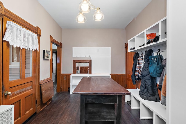 mudroom with dark hardwood / wood-style floors and wood walls