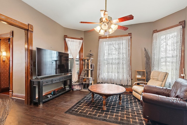 living room with ceiling fan and dark hardwood / wood-style flooring