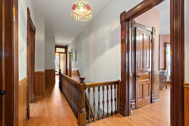 hall featuring wood walls and light hardwood / wood-style floors