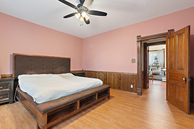 bedroom with ceiling fan and light hardwood / wood-style floors