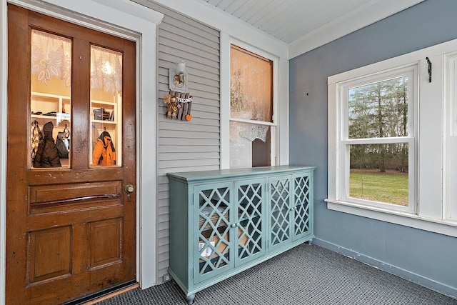 view of exterior entry featuring covered porch