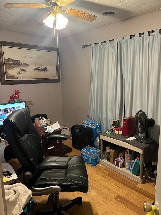 home office with a textured ceiling, hardwood / wood-style flooring, and ceiling fan