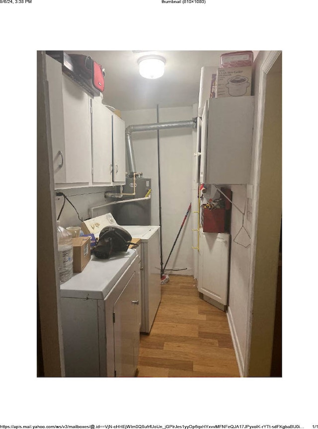 laundry area featuring light hardwood / wood-style floors, cabinets, water heater, and washing machine and clothes dryer