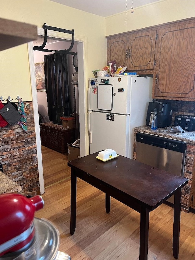 kitchen featuring dishwasher, white refrigerator, and light hardwood / wood-style flooring