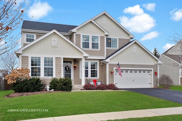 craftsman house featuring a front yard and a garage