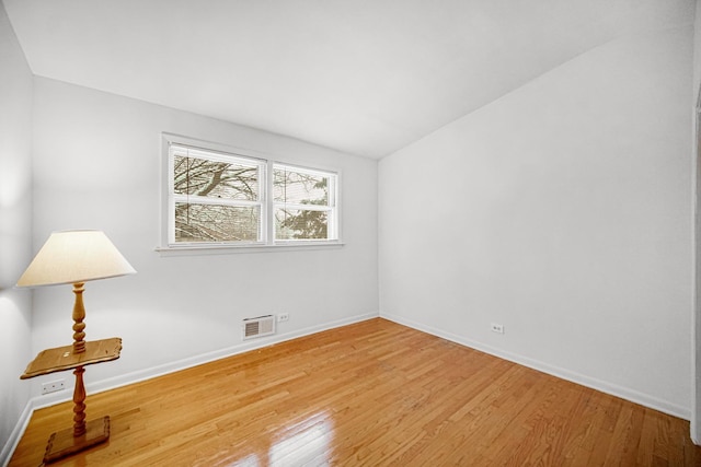 spare room with wood-type flooring