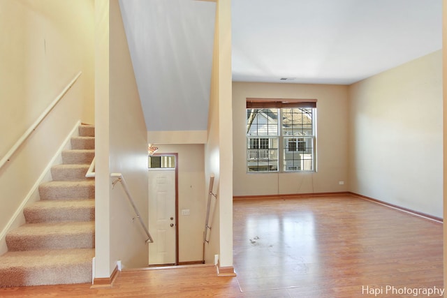 stairway with hardwood / wood-style flooring