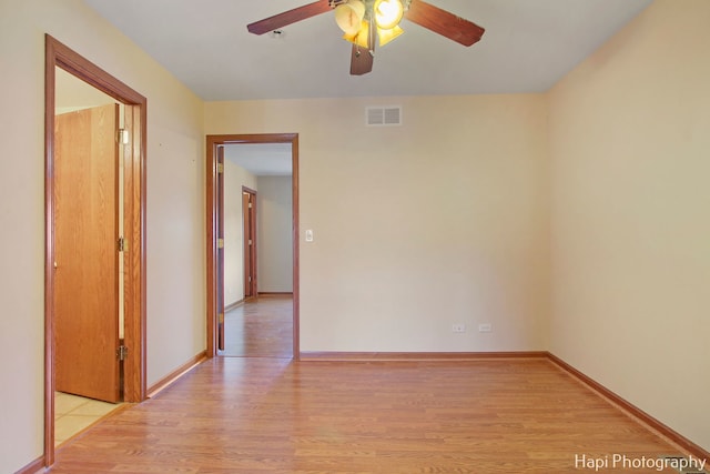 empty room featuring ceiling fan and light hardwood / wood-style flooring