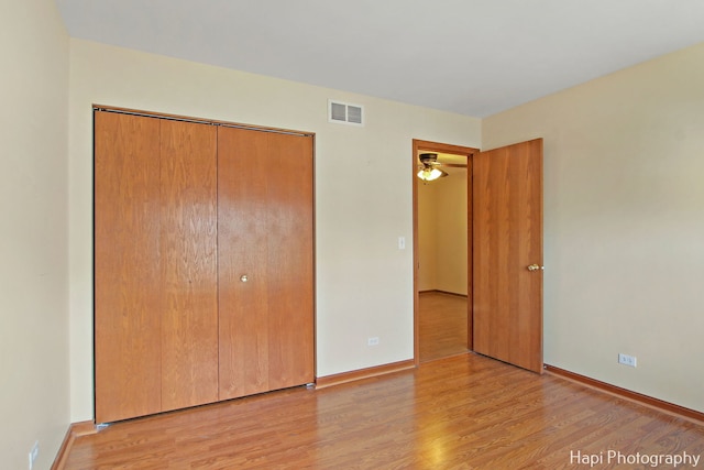 unfurnished bedroom with a closet and light hardwood / wood-style flooring