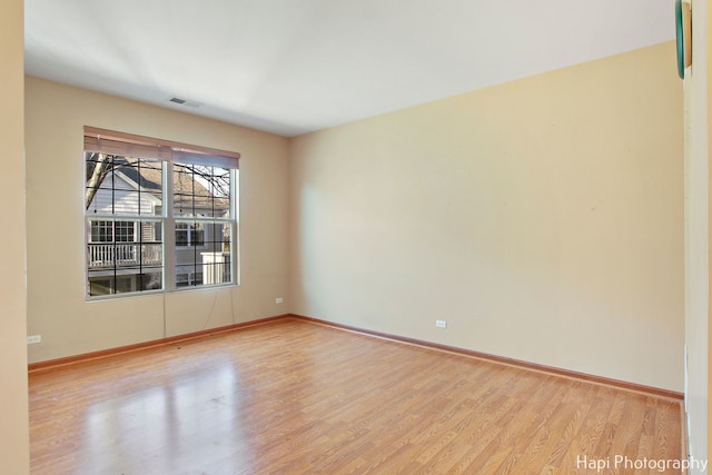 spare room with light hardwood / wood-style flooring