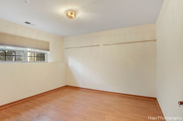 unfurnished room with wood-type flooring