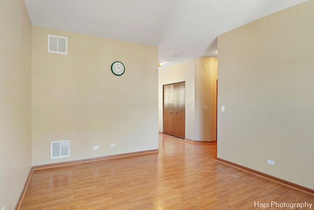 spare room with light hardwood / wood-style flooring