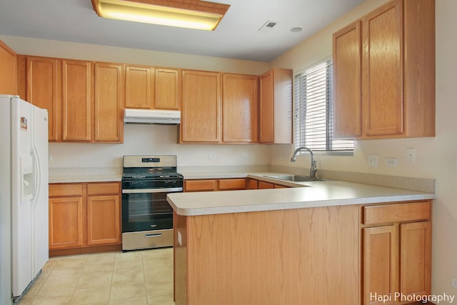 kitchen featuring white refrigerator with ice dispenser, sink, kitchen peninsula, and stainless steel range oven