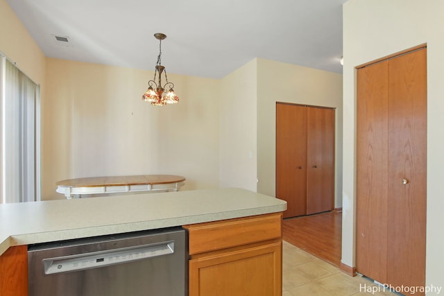 kitchen with dishwasher, pendant lighting, light wood-type flooring, and an inviting chandelier