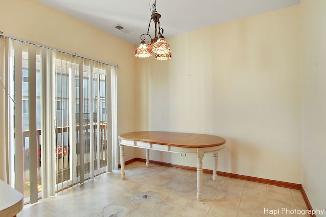 dining space featuring light tile patterned flooring