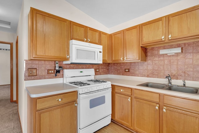 kitchen featuring sink, backsplash, light colored carpet, vaulted ceiling, and white appliances