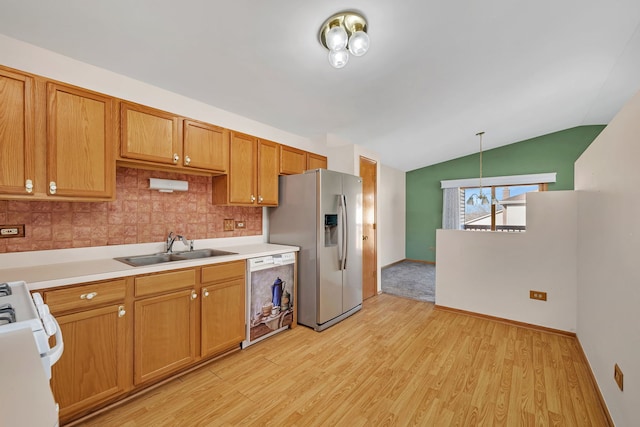 kitchen with dishwasher, light hardwood / wood-style flooring, lofted ceiling, and sink