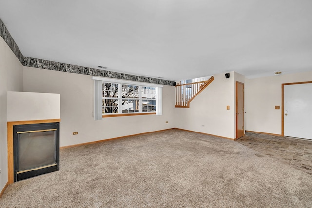 unfurnished living room featuring carpet