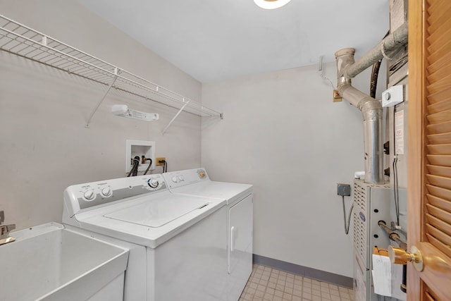 laundry room with washing machine and dryer and sink