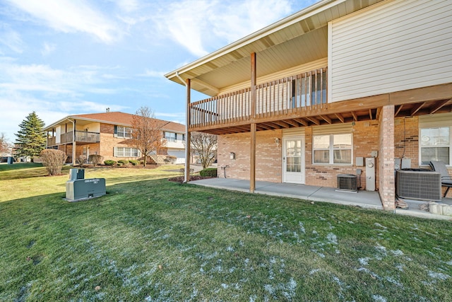 back of property with a patio, central AC unit, and a lawn