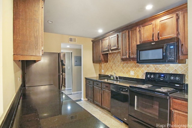 kitchen with tasteful backsplash, sink, and black appliances