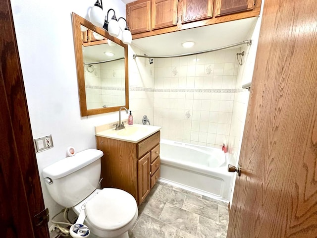 full bathroom with toilet, vanity, and tiled shower / bath