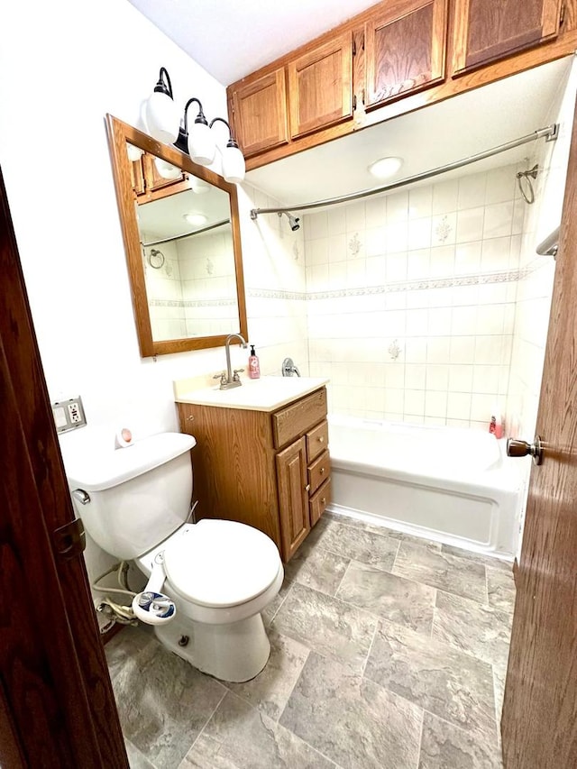 full bathroom featuring toilet, vanity, and tiled shower / bath combo