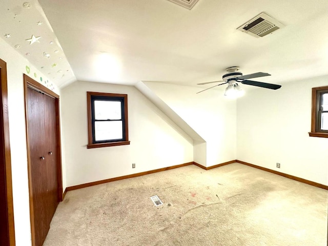 bonus room with carpet flooring, vaulted ceiling, and ceiling fan