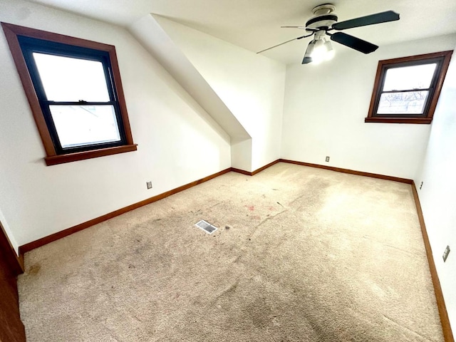 bonus room with ceiling fan, vaulted ceiling, and carpet