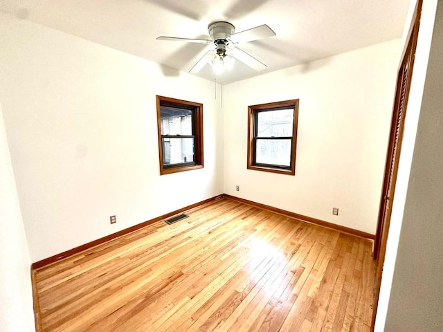 spare room with light wood-type flooring and ceiling fan